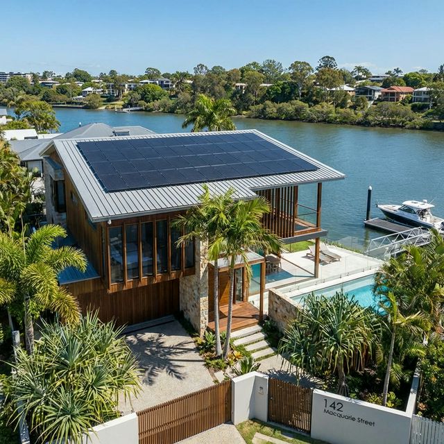 A high quality realistic residential home in St Lucia Queensland with a brand new solar panel array on the roof